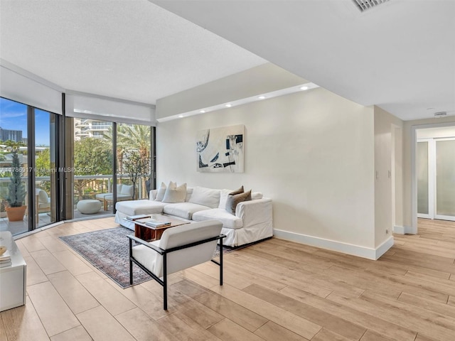 20191 E Country Club Dr Unit 311, Aventura, FL 33180 - living room with a wall of windows, baseboards, recessed lighting, and light wood-style floors