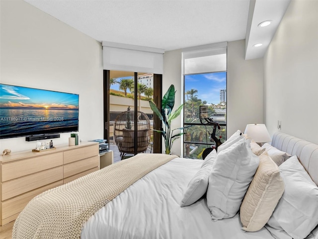 20191 E Country Club Dr Unit 311, Aventura, FL 33180 - bedroom with wood finished floors, floor to ceiling windows, access to exterior, and recessed lighting