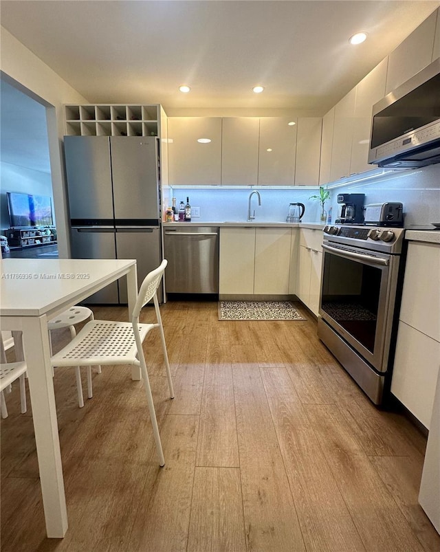 575 Crandon Blvd Unit 707, Key Biscayne, FL 33149 - kitchen with light wood-type flooring, modern cabinets, appliances with stainless steel finishes, light countertops, and white cabinetry