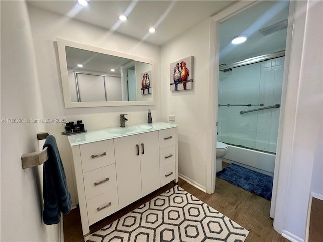 575 Crandon Blvd Unit 707, Key Biscayne, FL 33149 - full bath featuring wood finished floors, vanity, bath / shower combo with glass door, baseboards, and toilet