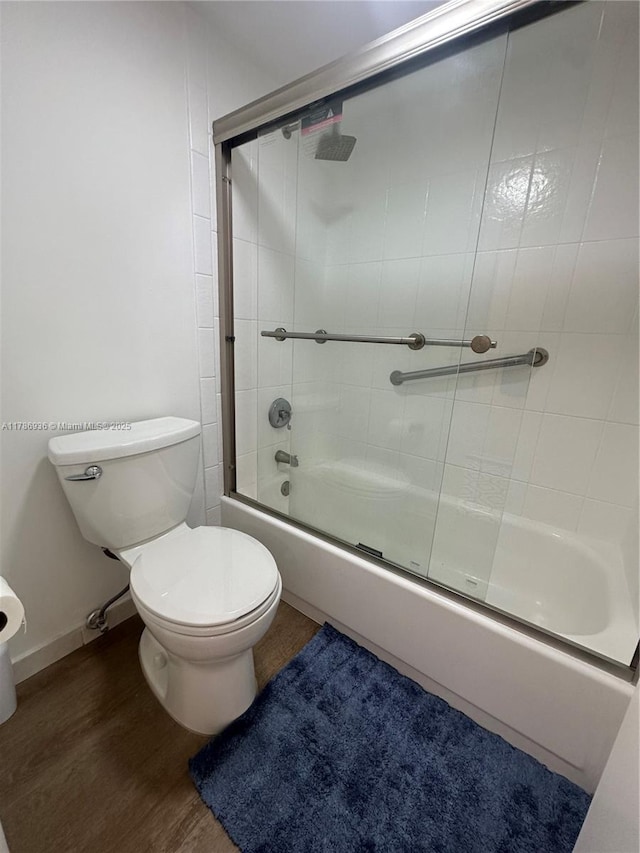 575 Crandon Blvd Unit 707, Key Biscayne, FL 33149 - full bath with baseboards, wood finished floors, shower / bath combination with glass door, and toilet