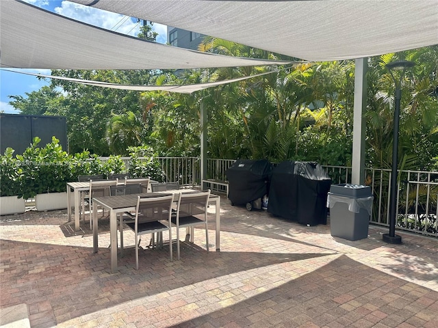 575 Crandon Blvd Unit 707, Key Biscayne, FL 33149 - view of patio with outdoor dining area, fence, and area for grilling