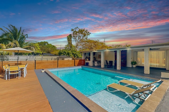 9925 SW 82nd Ave, Miami, FL 33156 - pool at dusk with a fenced backyard, a patio, and outdoor dining area