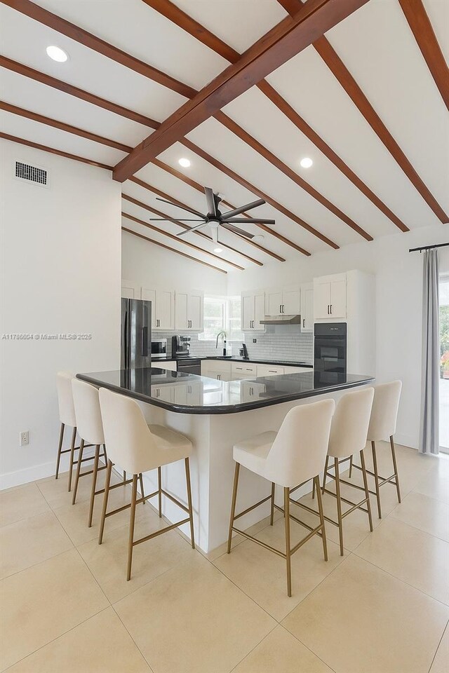 9925 SW 82nd Ave, Miami, FL 33156 - kitchen featuring fridge, recessed lighting, white cabinets, dark countertops, and a kitchen bar