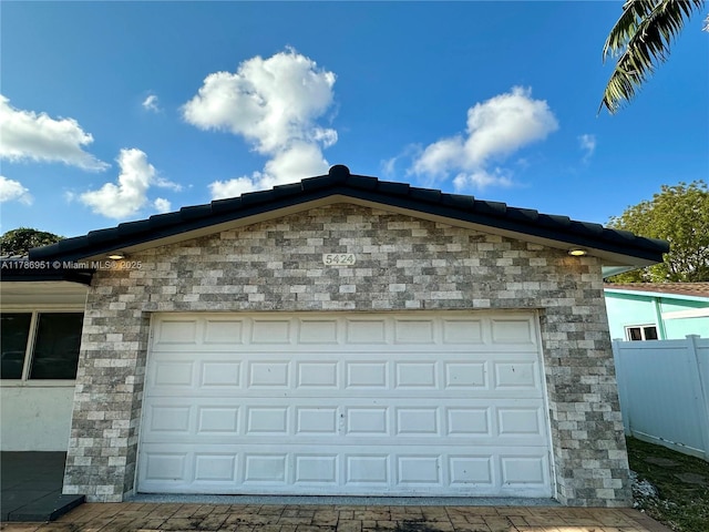 5424 Garfield St, Hollywood, FL 33021 - garage featuring driveway and fence