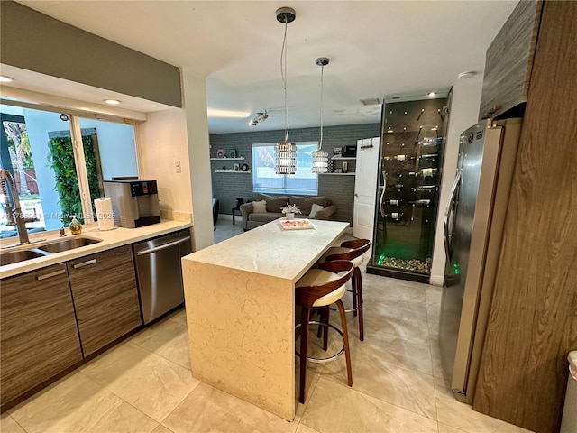 5424 Garfield St, Hollywood, FL 33021 - kitchen featuring brown cabinets, modern cabinets, a sink, light countertops, and appliances with stainless steel finishes