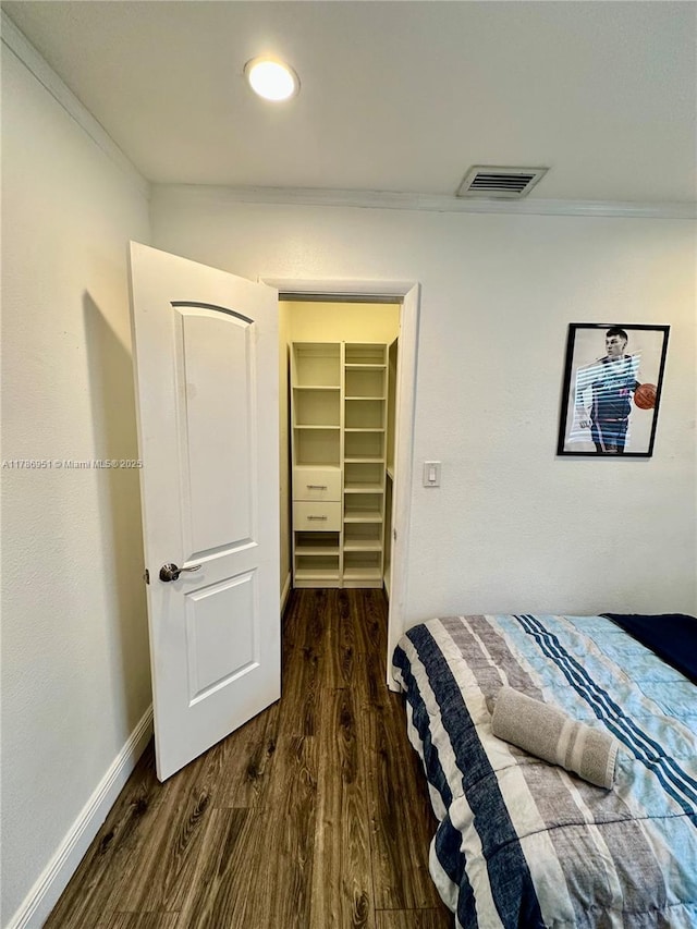 5424 Garfield St, Hollywood, FL 33021 - bedroom with dark wood-style floors, visible vents, ornamental molding, and baseboards