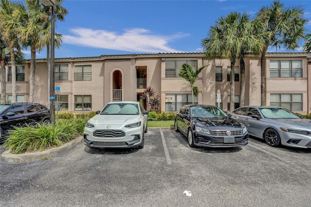 view of property with uncovered parking