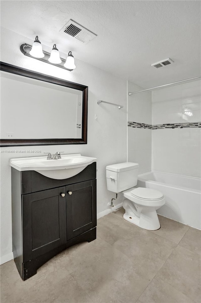 bathroom featuring a textured ceiling, toilet, vanity, and visible vents