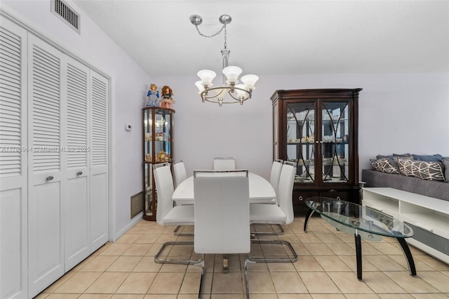 3800 Hillcrest Dr Unit 210, Hollywood, FL 33021 - dining space featuring a chandelier, light tile patterned floors, and baseboards