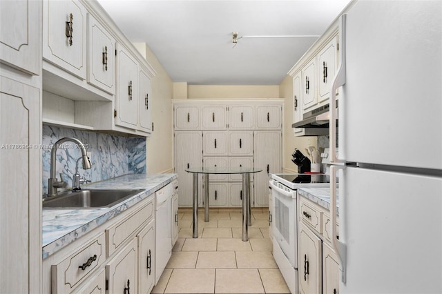 3800 Hillcrest Dr Unit 210, Hollywood, FL 33021 - kitchen featuring white appliances, under cabinet range hood, a sink, light countertops, and white cabinets