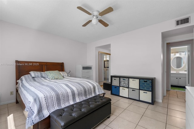 3800 Hillcrest Dr Unit 210, Hollywood, FL 33021 - bedroom featuring light tile patterned floors, ensuite bathroom, baseboards, and a ceiling fan