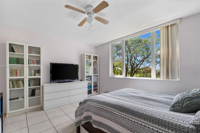 3800 Hillcrest Dr Unit 210, Hollywood, FL 33021 - bedroom featuring a textured ceiling, light tile patterned floors, and a ceiling fan