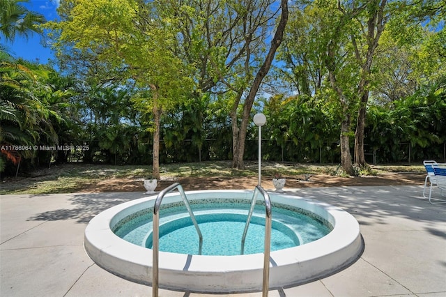 3800 Hillcrest Dr Unit 210, Hollywood, FL 33021 - view of pool with a hot tub and view of wooded area