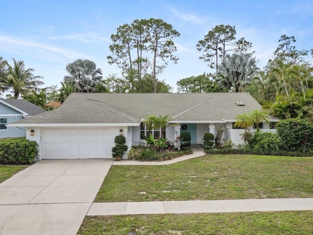 710 Daffodil Dr, Wellington, FL 33414 - ranch-style house with concrete driveway, a front yard, and a garage