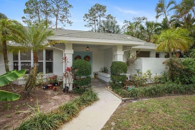 710 Daffodil Dr, Wellington, FL 33414 - entrance to property with fence, stucco siding, and roof with shingles