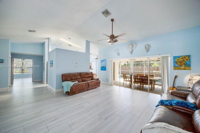 710 Daffodil Dr, Wellington, FL 33414 - living room featuring a healthy amount of sunlight, visible vents, a ceiling fan, and vaulted ceiling