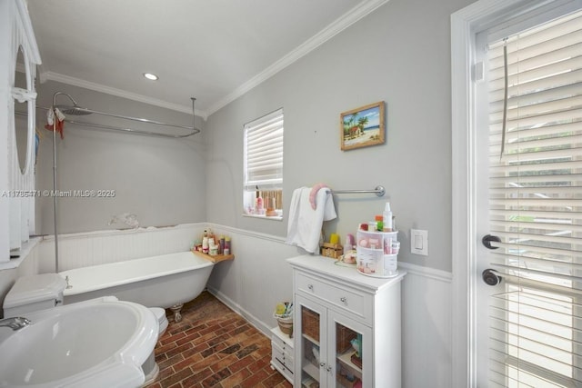 710 Daffodil Dr, Wellington, FL 33414 - bathroom with a soaking tub, a sink, ornamental molding, brick floor, and wainscoting
