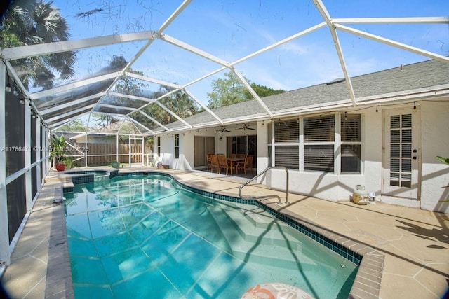 710 Daffodil Dr, Wellington, FL 33414 - view of swimming pool featuring a patio, glass enclosure, fence, a ceiling fan, and a pool with connected hot tub