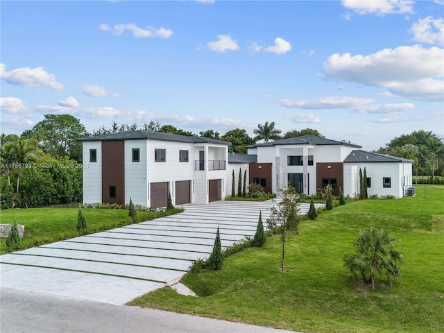 contemporary home featuring a front lawn, driveway, and an attached garage