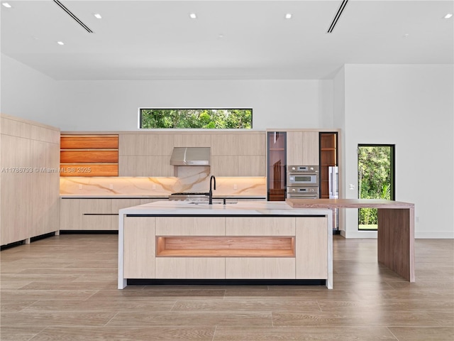 unfurnished bedroom featuring light wood-type flooring, a sink, and recessed lighting