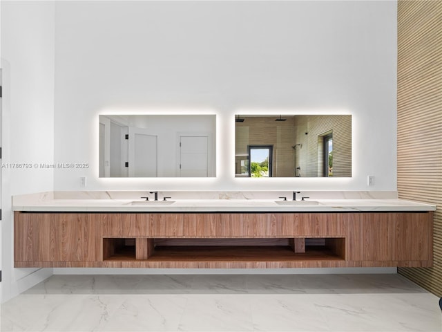 bathroom with marble finish floor, a sink, and double vanity