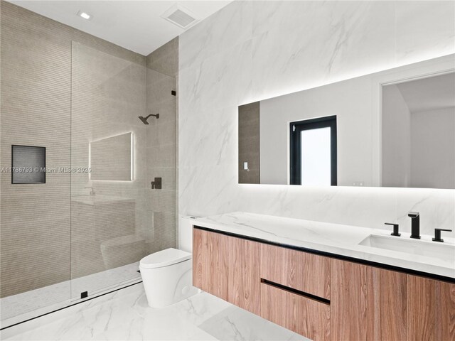 bathroom featuring toilet, visible vents, marble finish floor, a shower stall, and vanity