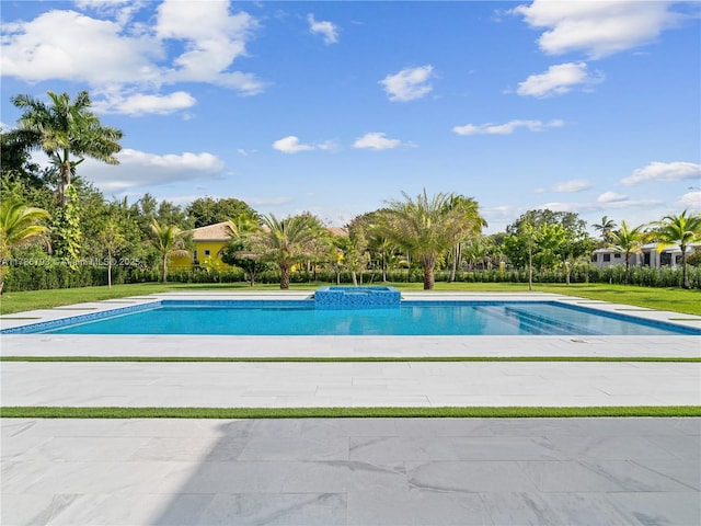 outdoor pool featuring a yard