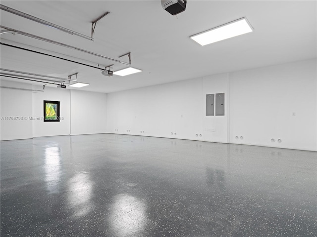 garage featuring electric panel and a garage door opener