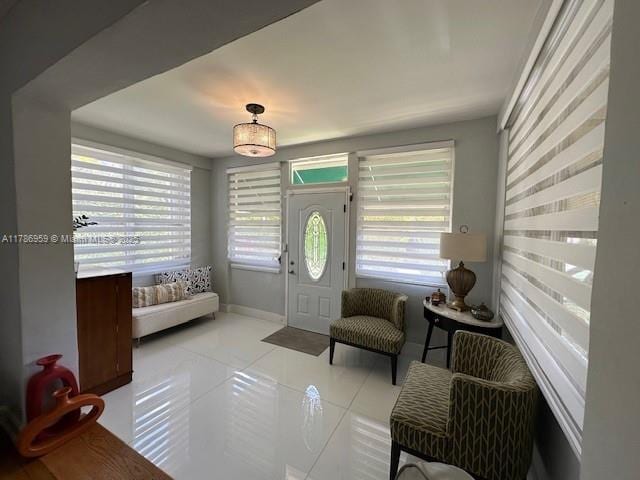 foyer entrance featuring baseboards and tile patterned floors