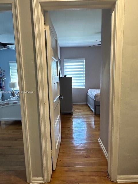 hall with wood finished floors and baseboards