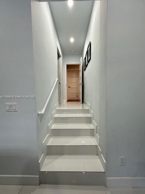 stairway featuring baseboards