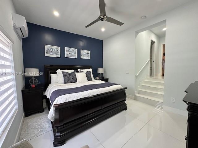 bedroom with recessed lighting, a wall mounted AC, a ceiling fan, and baseboards