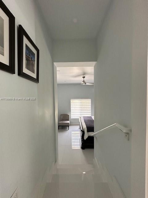 hall with tile patterned flooring and baseboards