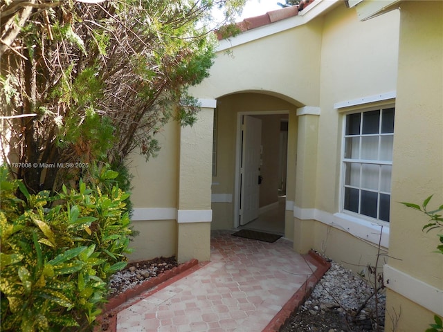 property entrance with stucco siding