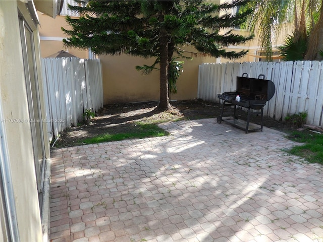 view of patio with fence and area for grilling