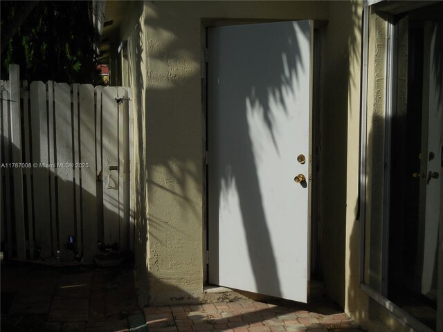 entrance to property with stucco siding