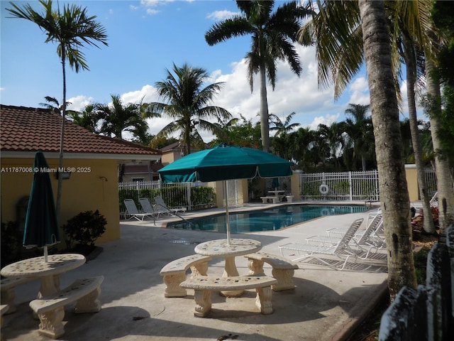 community pool featuring a patio area and fence