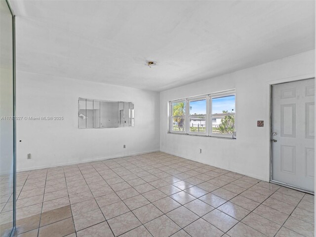 22534 SW 114th Pl, Miami, FL 33170 - spare room with tile patterned flooring and baseboards