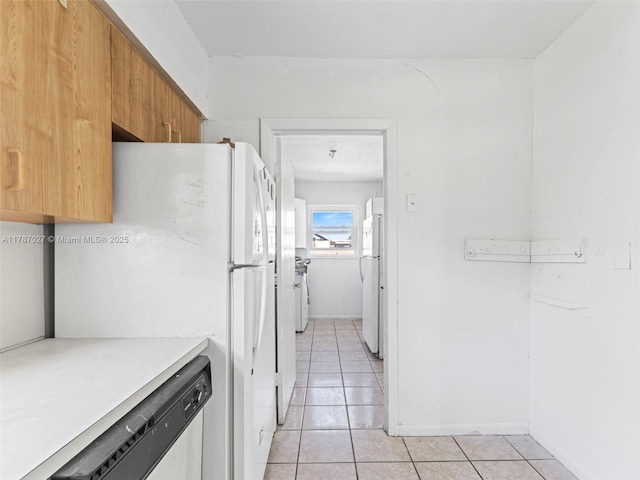 22534 SW 114th Pl, Miami, FL 33170 - kitchen featuring light tile patterned floors, freestanding refrigerator, dishwasher, and light countertops