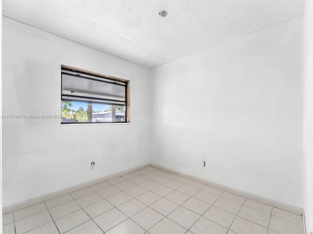 22534 SW 114th Pl, Miami, FL 33170 - spare room featuring a textured ceiling and baseboards