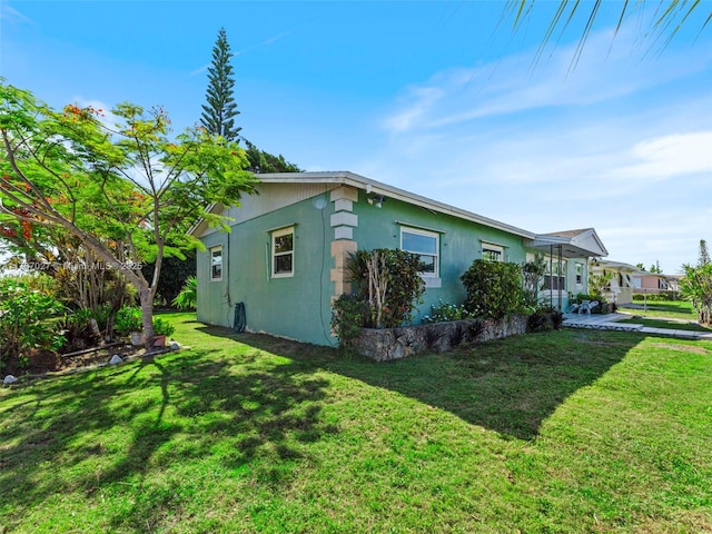 22534 SW 114th Pl, Miami, FL 33170 - view of property exterior with stucco siding and a yard