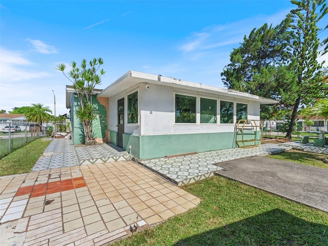 22534 SW 114th Pl, Miami, FL 33170 - view of side of home with stucco siding and a patio area