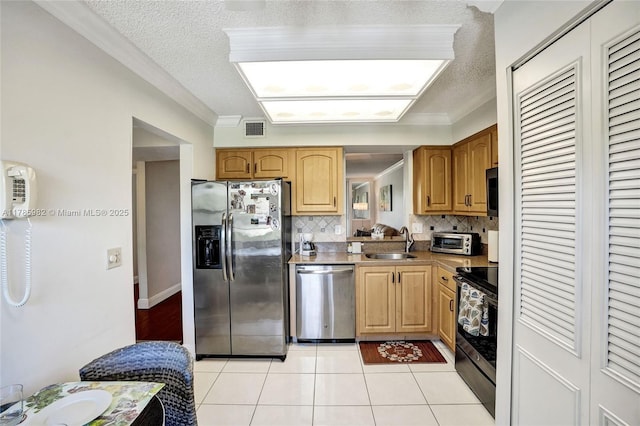370 NW 76th Ave Unit 307, Margate, FL 33063 - kitchen featuring appliances with stainless steel finishes, a textured ceiling, tasteful backsplash, light tile patterned floors, and ornamental molding