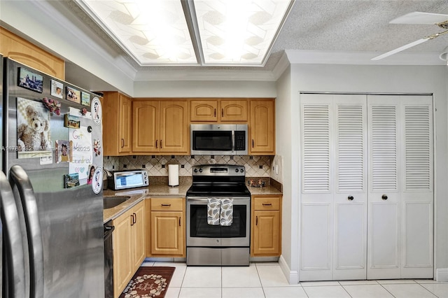 370 NW 76th Ave Unit 307, Margate, FL 33063 - kitchen featuring appliances with stainless steel finishes, light tile patterned flooring, crown molding, and backsplash