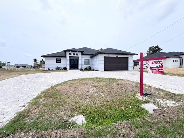 314 Chiquita Blvd N, Cape Coral, FL 33993 - prairie-style house with an attached garage and decorative driveway