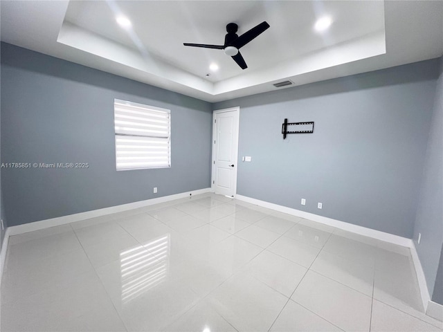 314 Chiquita Blvd N, Cape Coral, FL 33993 - spare room with a tray ceiling, ceiling fan, baseboards, and tile patterned flooring