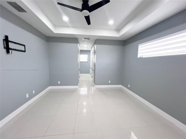 314 Chiquita Blvd N, Cape Coral, FL 33993 - empty room with a tray ceiling, ceiling fan, and baseboards