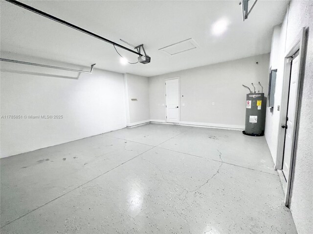 garage featuring water heater and a garage door opener