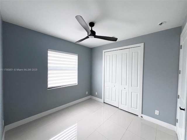314 Chiquita Blvd N, Cape Coral, FL 33993 - unfurnished bedroom featuring baseboards, a closet, ceiling fan, and tile patterned flooring